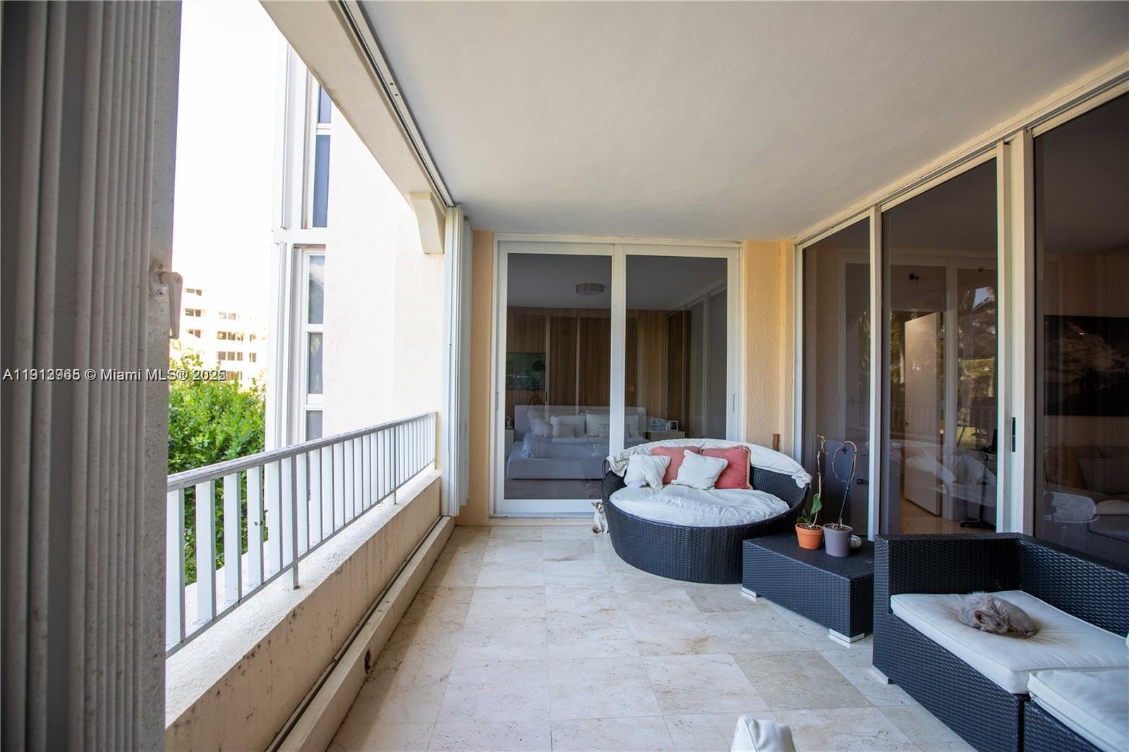 721 Crandon Boulevard, Unit 207 Key Biscayne, FL 33149 - Photo 6 of 8 a living room with furniture and a large window
