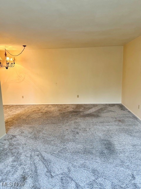 3068 Kent Road, Unit 211 Stow, OH 44224 - Photo 11 of 27 Empty room with carpet and a chandelier