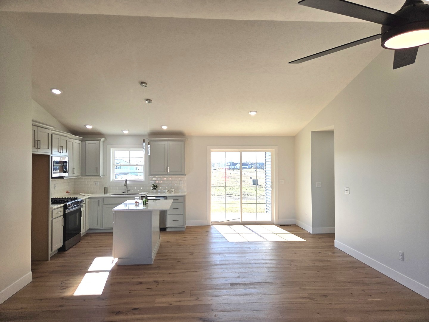 2203 Corrigan Way Normal, IL 61761 - Photo 12 of 51 a kitchen with stainless steel appliances granite countertop a refrigerator a sink dishwasher a stove and a dining table with wooden floor