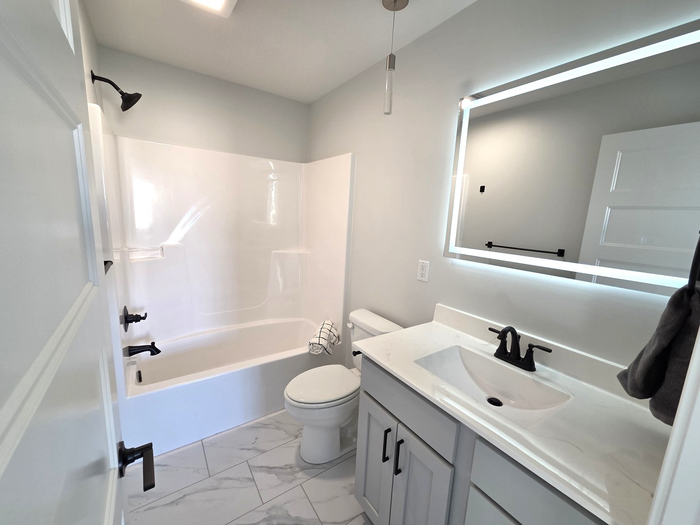 2203 Corrigan Way Normal, IL 61761 - Photo 30 of 51 a bathroom with a bathtub shower sink vanity mirror and toilet