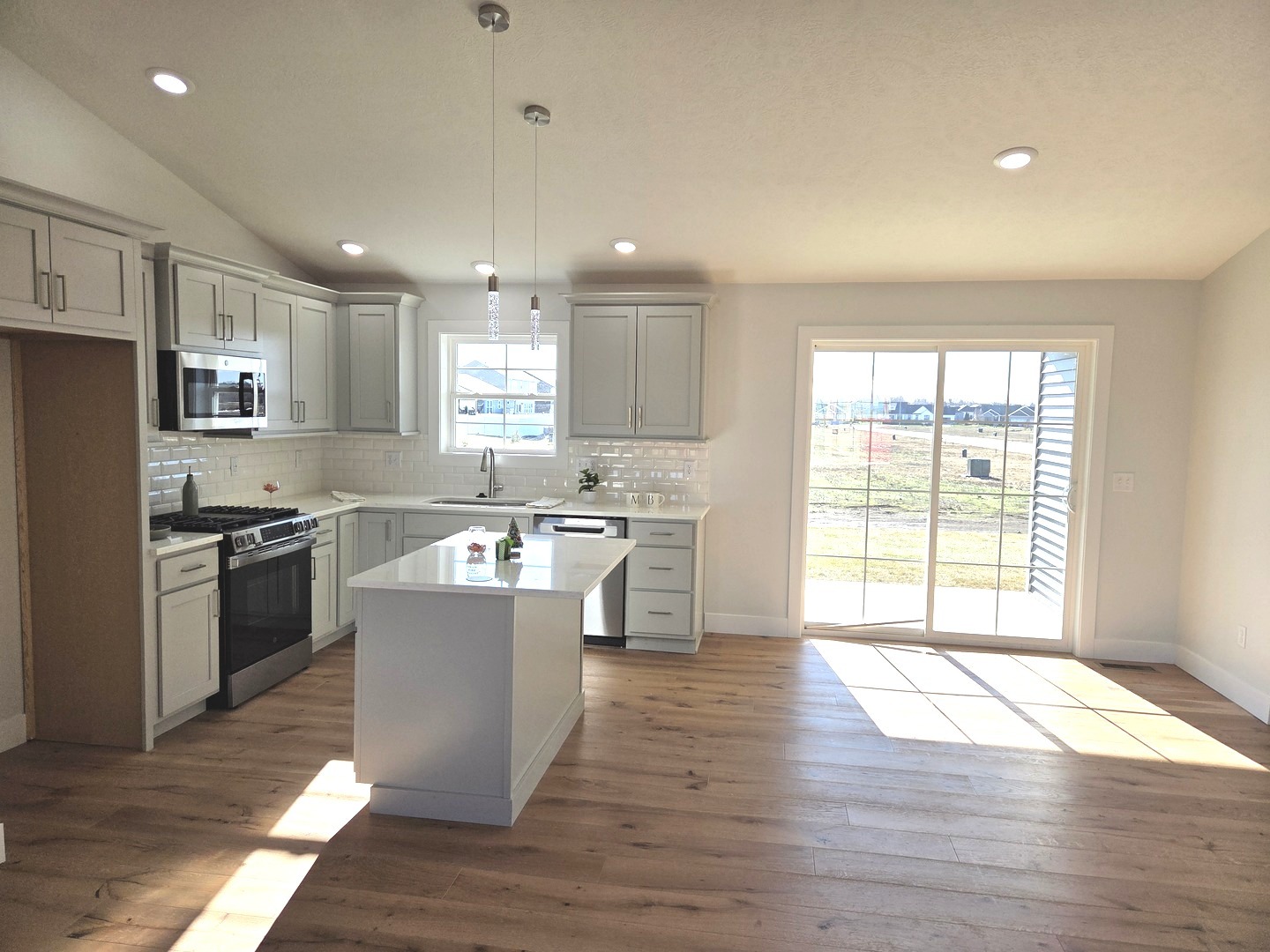 2203 Corrigan Way Normal, IL 61761 - Photo 5 of 51 a kitchen with a sink wooden floor and stainless steel appliances