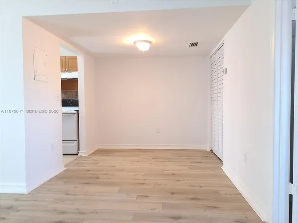 a kitchen with granite countertop a sink stove and cabinets