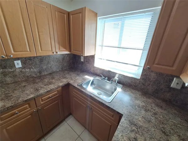 a view of an empty room and wooden floor
