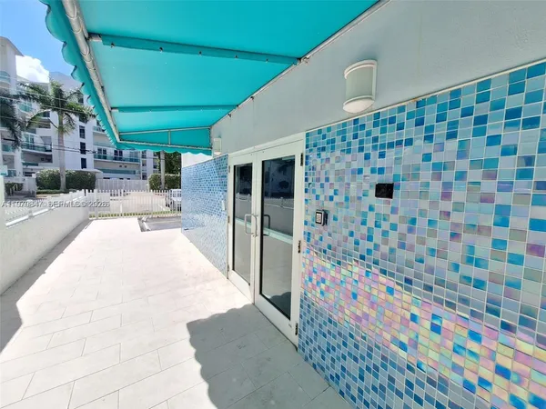 a lobby with a rug and a white door