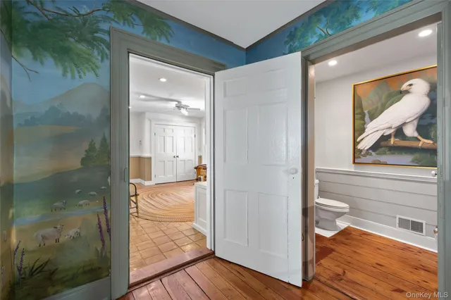 a bathroom with a glass shower door and a window
