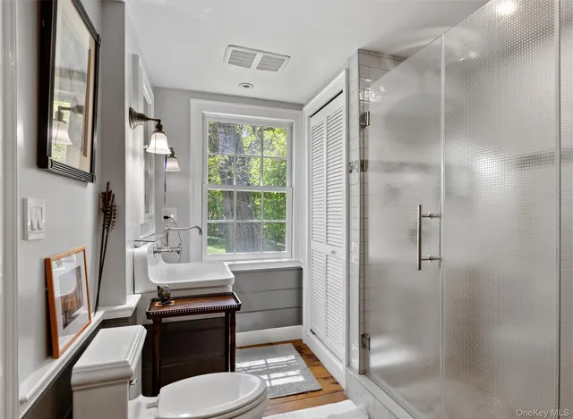 a bathroom with a sink toilet and shower