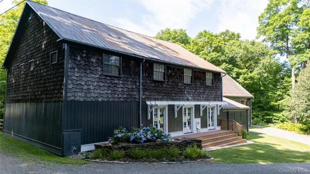 a front view of a house with a garden
