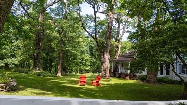 a view of a house with a yard porch and sitting area