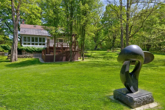 a view of a house with a yard and sitting area