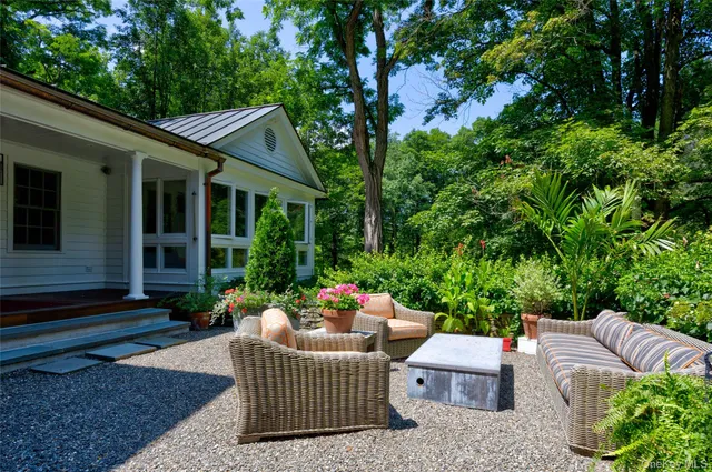 a patio with patio outdoor seating and green space