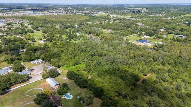an aerial view of residential houses with outdoor space and swimming pool