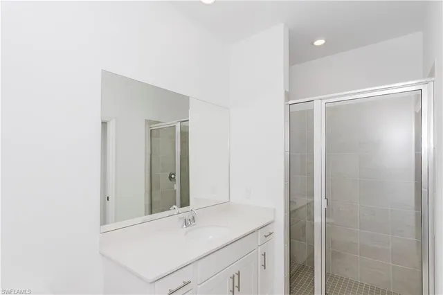 a bathroom with a shower sink and mirror