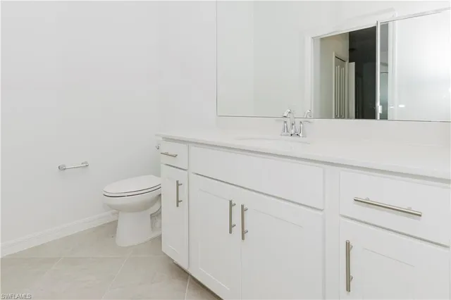 a bathroom with a sink a toilet and mirror