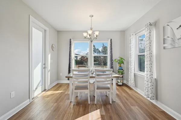 a large kitchen with lots of counter space a sink appliances and a dining table