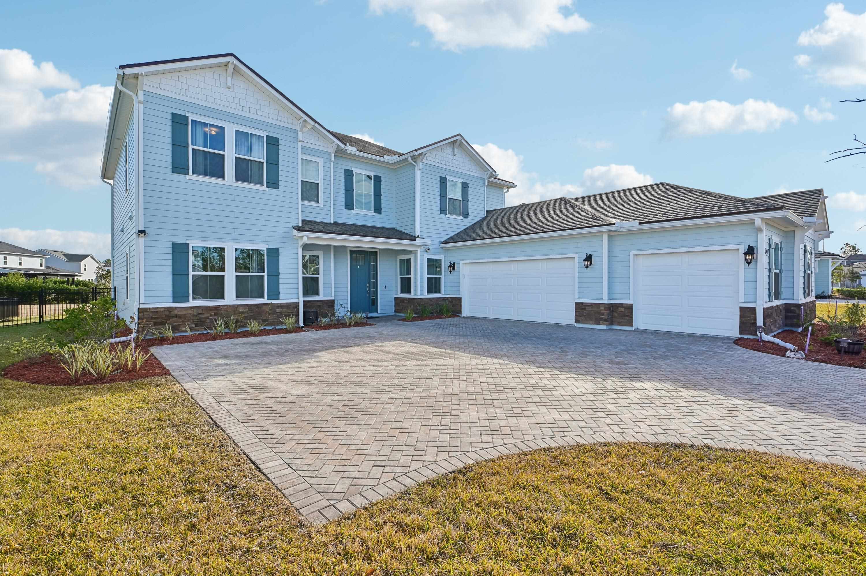 57 Sunset Ridge Court St. Johns, FL 32259 - Photo 2 of 79 a front view of a house with a yard and garage