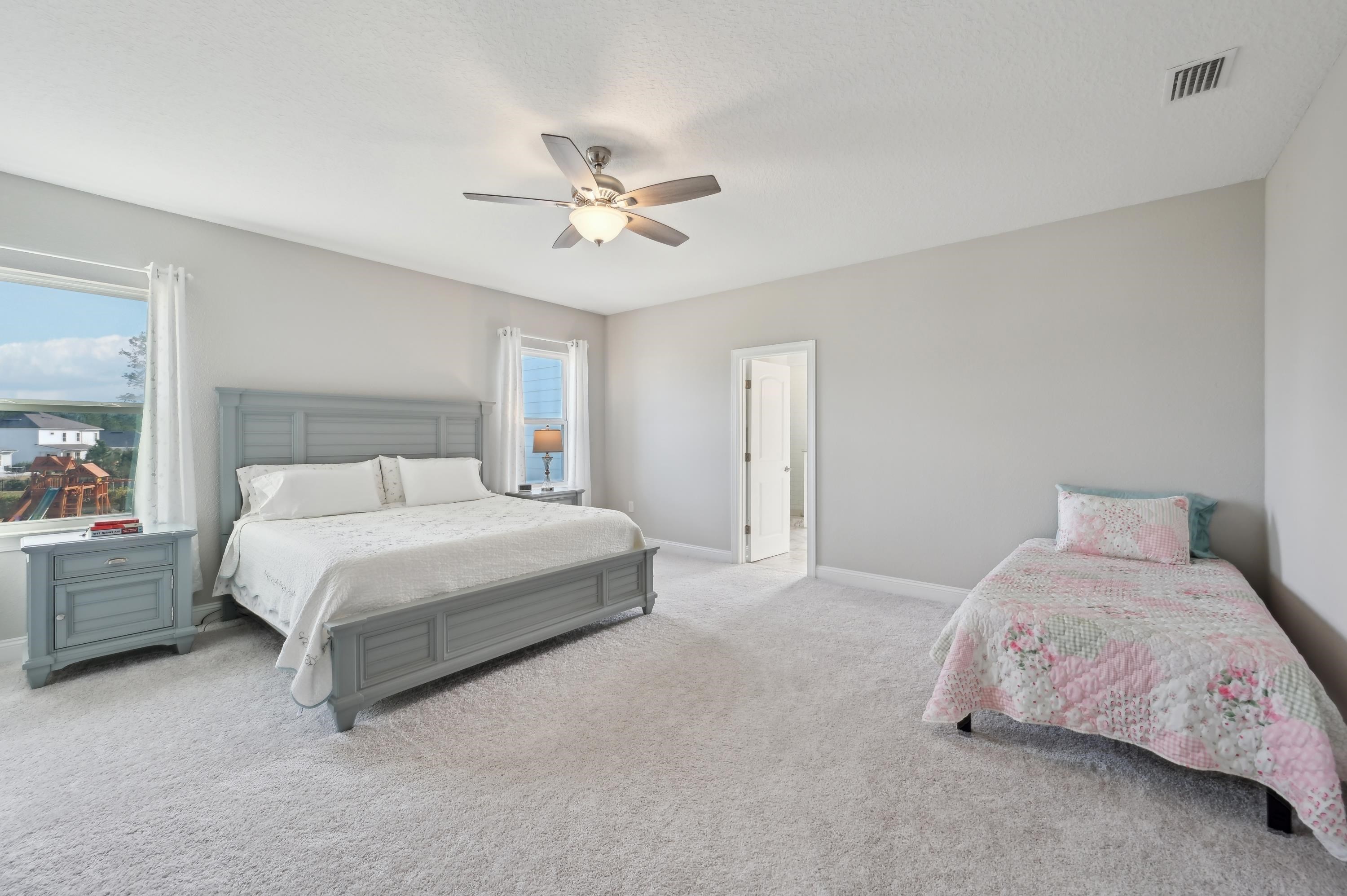 57 Sunset Ridge Court St. Johns, FL 32259 - Photo 45 of 79 a bedroom with a bed and a chandelier