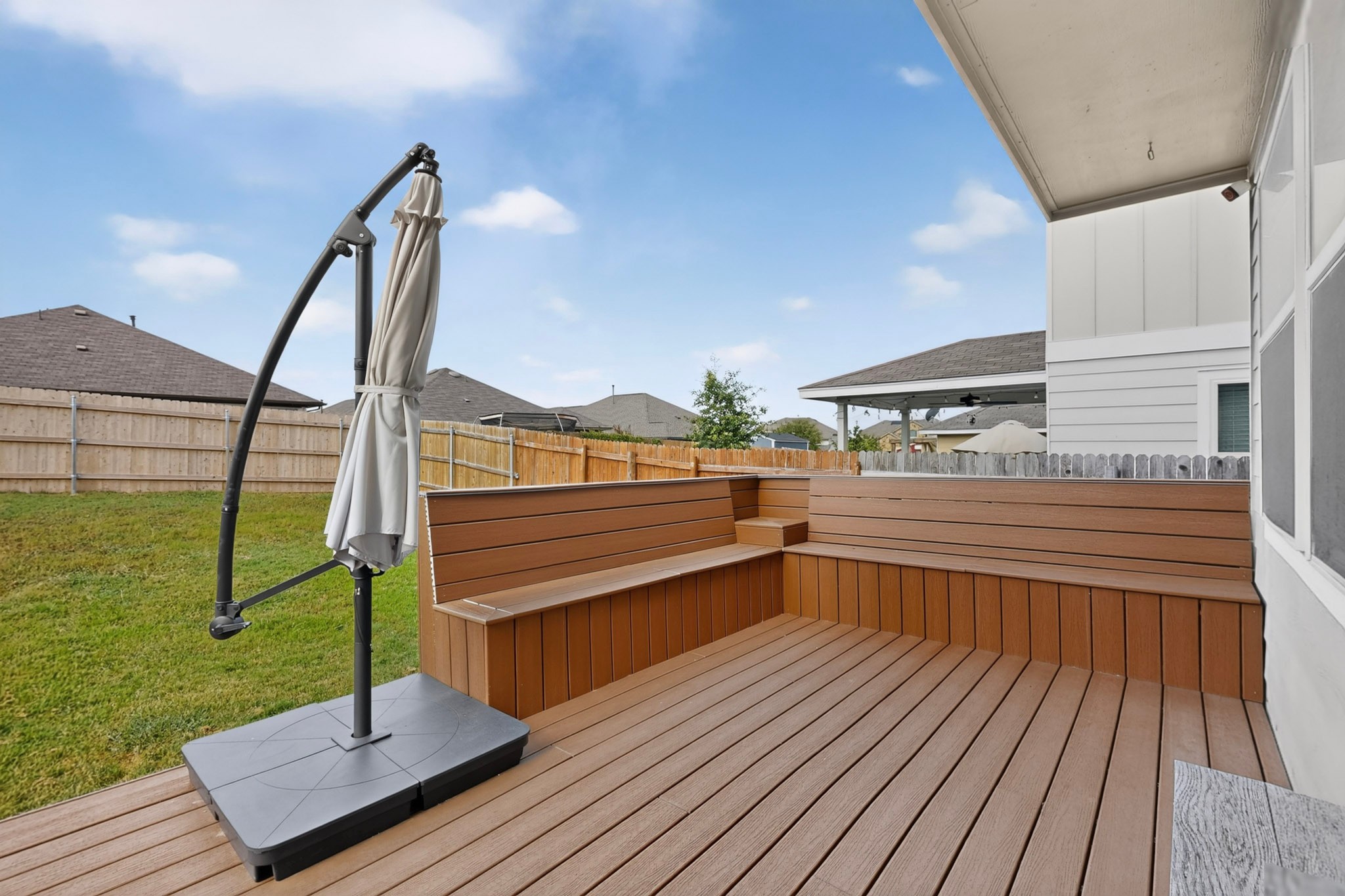 132 Wapiti Road Buda, TX 78610 - Photo 23 of 31 A newly constructed deck with built-in seating creates a functional outdoor living space.