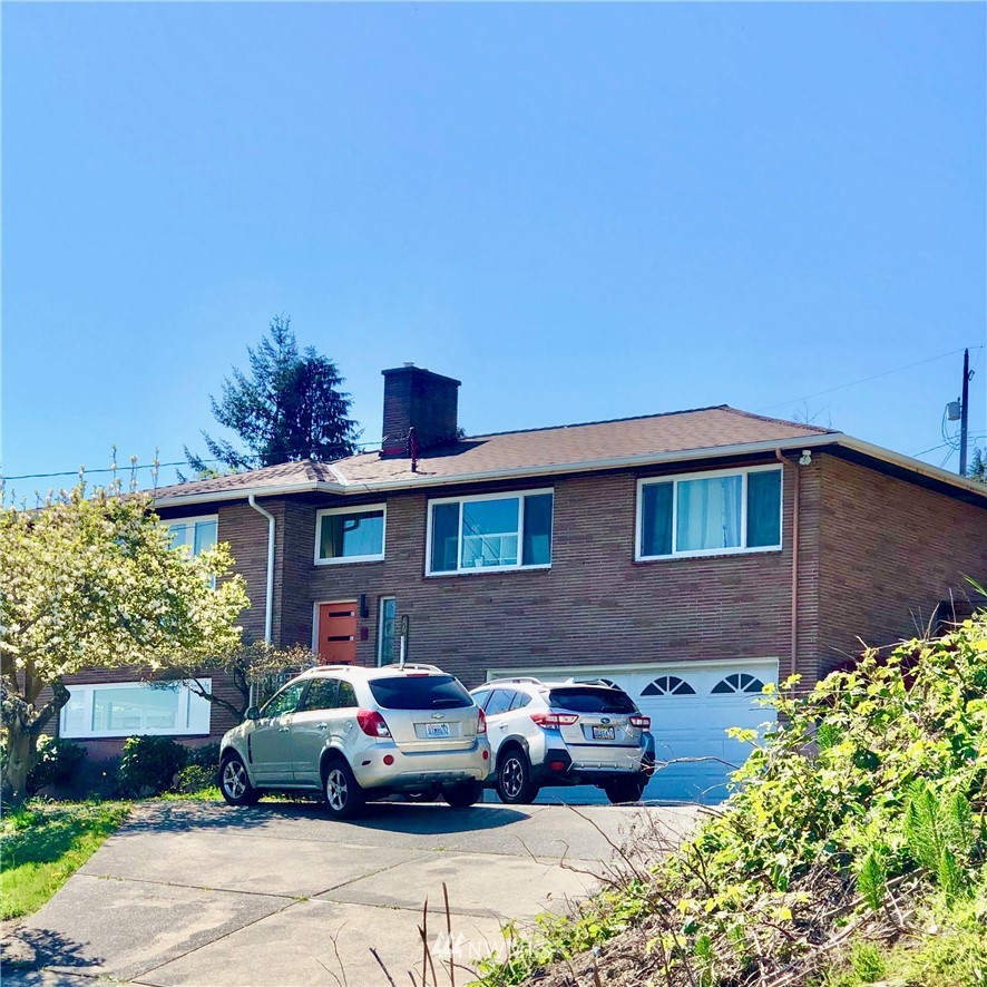 16625 8th Place Southwest Burien, WA 98166 - Photo 1 of 1 a front view of a house with a garden