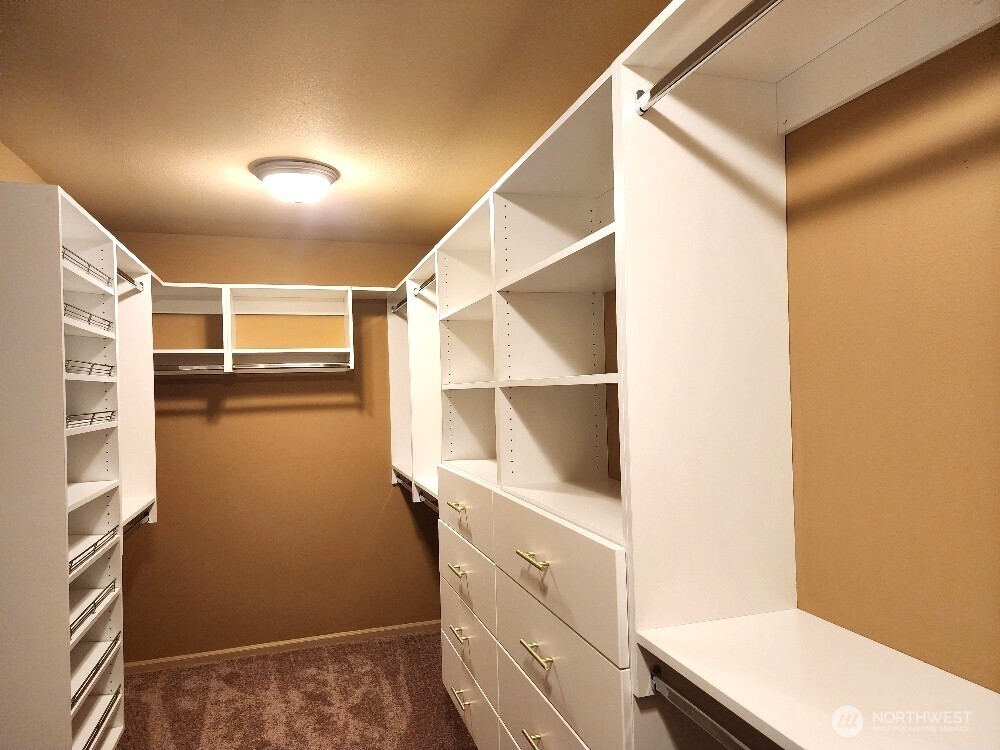 16200 Parkside Way Southeast Renton, WA 98058 - Photo 19 of 40 a view of walk in closet with clothes and shoes