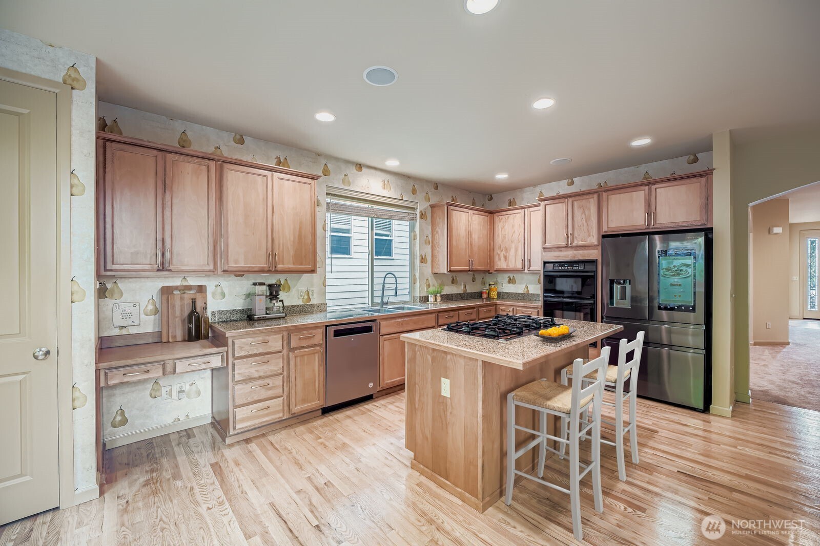 16200 Parkside Way Southeast Renton, WA 98058 - Photo 7 of 40 a kitchen with stainless steel appliances granite countertop a stove top oven a sink dishwasher a dining table and chairs with wooden floor