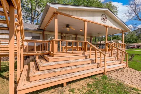a view of a house with a small deck