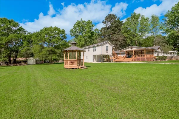 a view of a house with a backyard porch and sitting area