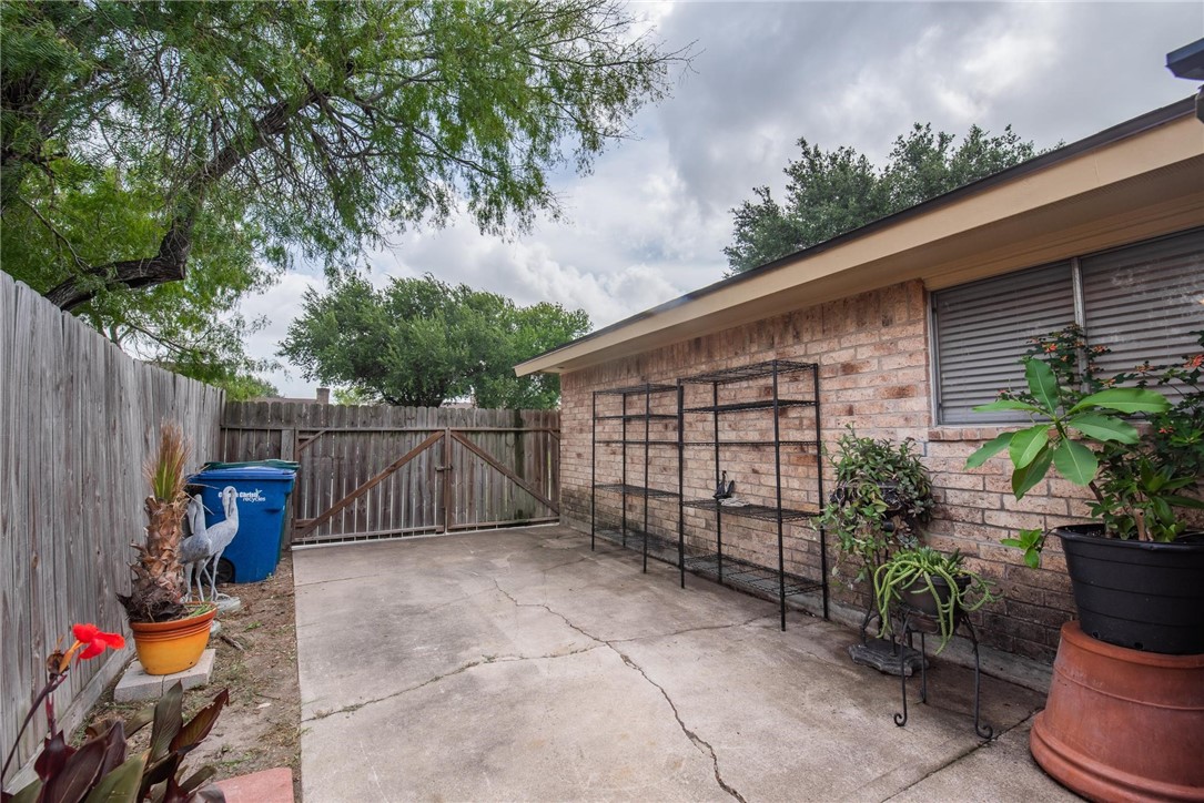 4957 Shadowbend Drive Corpus Christi, TX 78413 - Photo 15 of 35 a view of a backyard with a chair and potted plants