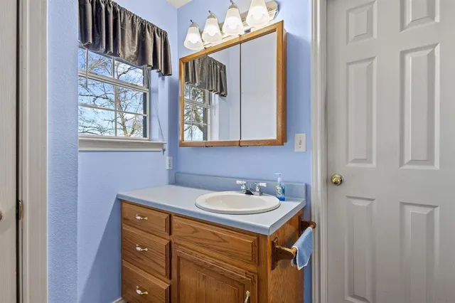 a bathroom with a sink and a mirror