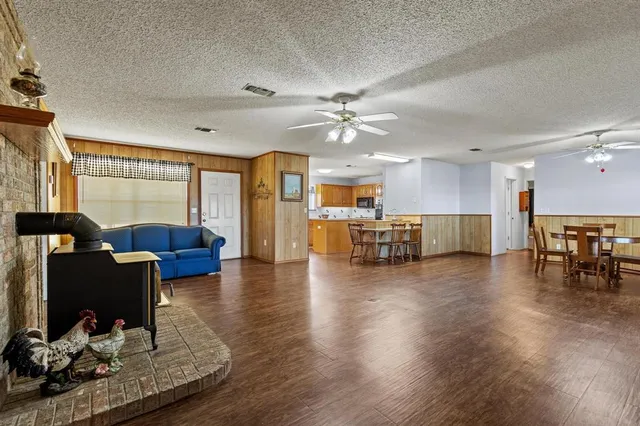 a living room with furniture and kitchen view