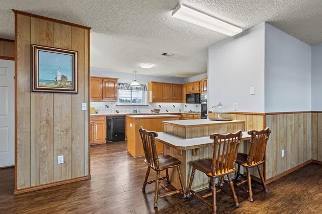 a kitchen with a table and chairs in it