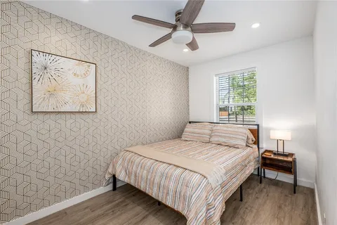 a bedroom with a bed and a ceiling fan