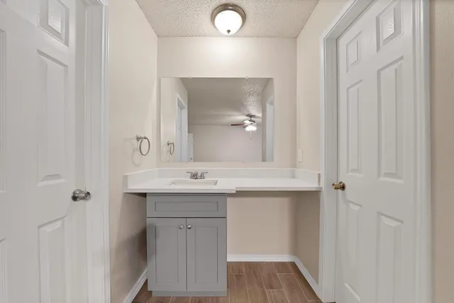 a bathroom with a sink and mirror with shower