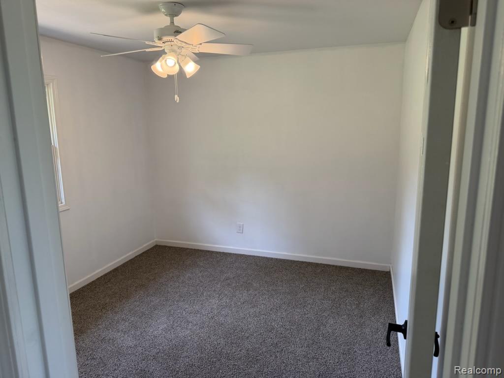 3515 Morton Road Stockbridge, MI 49285 - Photo 17 of 31 Bedroom featuring a ceiling fan with integrated lighting, window, white walls, and gray-flecked carpeting