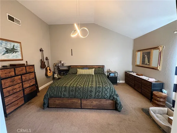 a bedroom with a bed and dresser