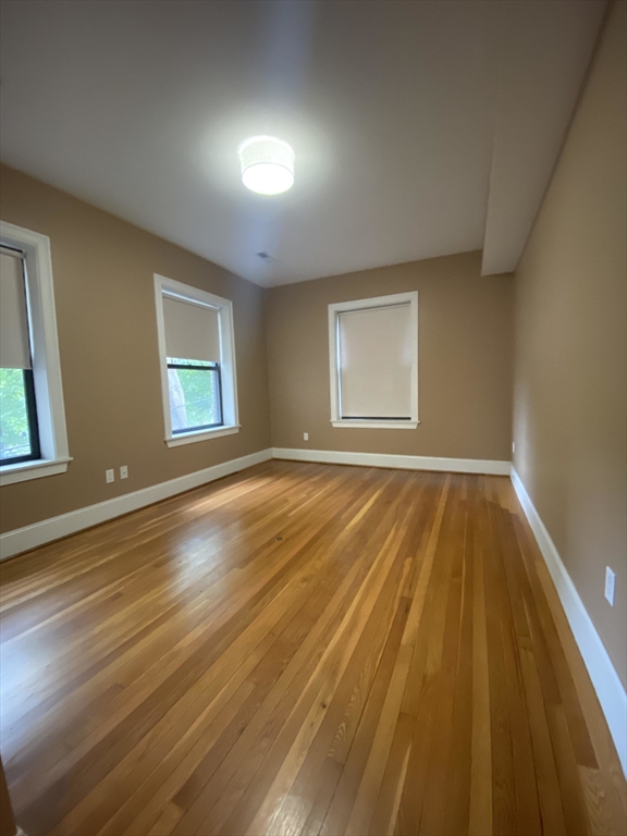 1592 Beacon Street, Unit 2 Brookline, MA 02446 - Photo 7 of 10 a view of a room with wooden floor and fan
