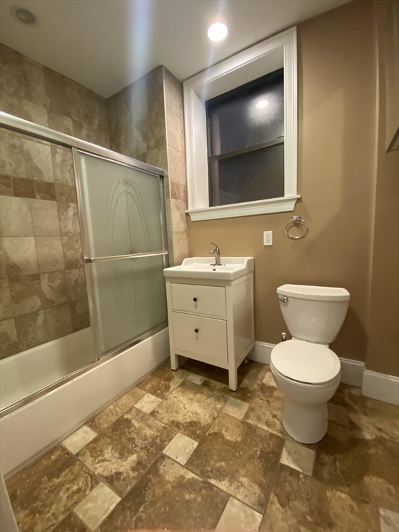 1592 Beacon Street, Unit 2 Brookline, MA 02446 - Photo 9 of 10 a bathroom with a toilet sink and a mirror