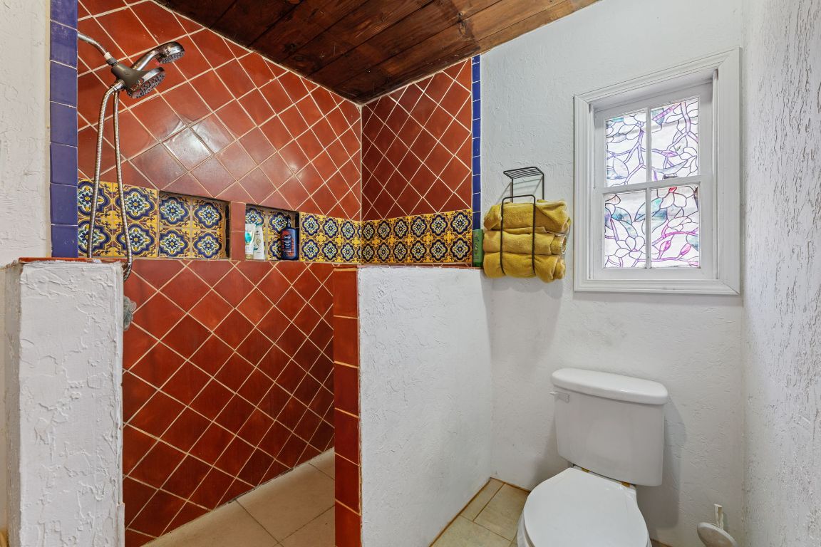274 Old Potato Road Paige, TX 78659 - Photo 15 of 40 a bathroom with a toilet and a shower curtain