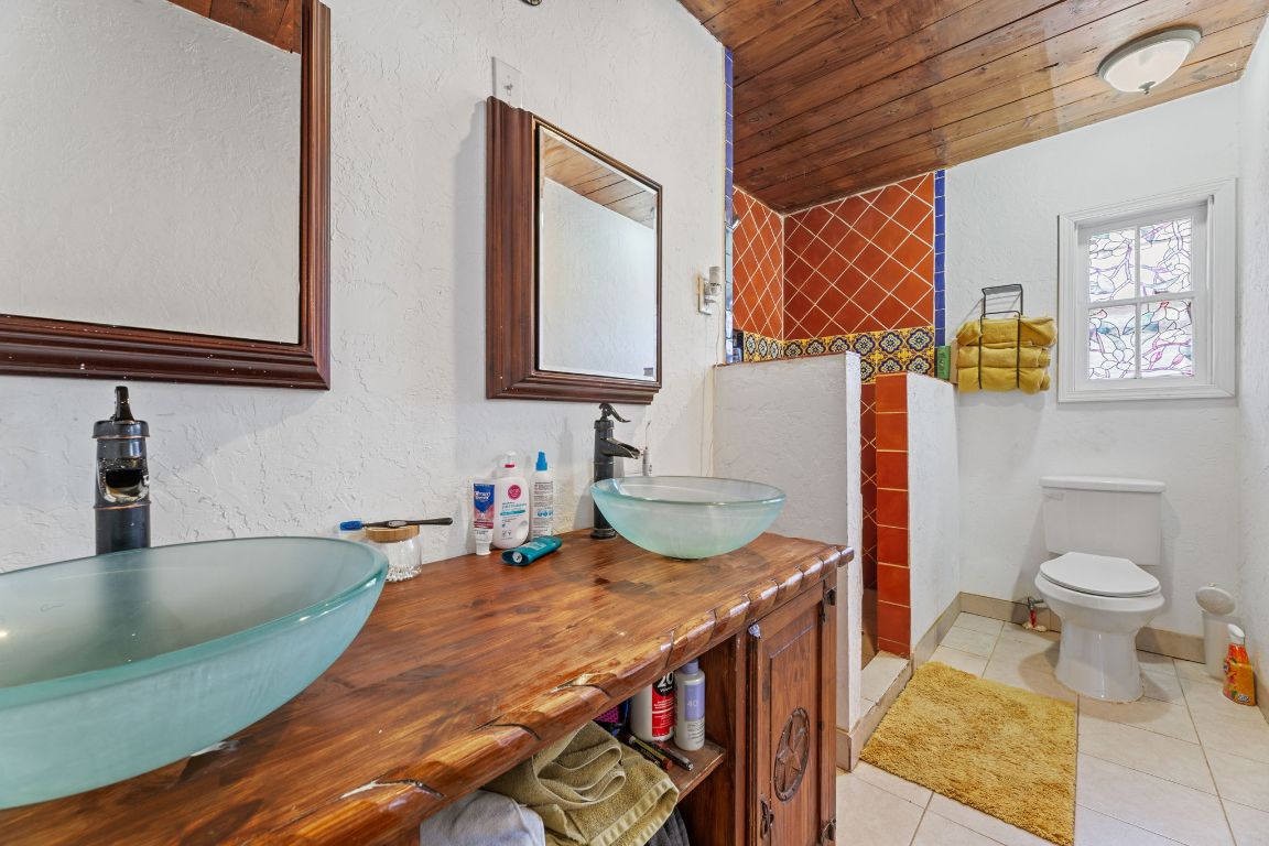 274 Old Potato Road Paige, TX 78659 - Photo 16 of 40 a bathroom with a sink a toilet and mirror