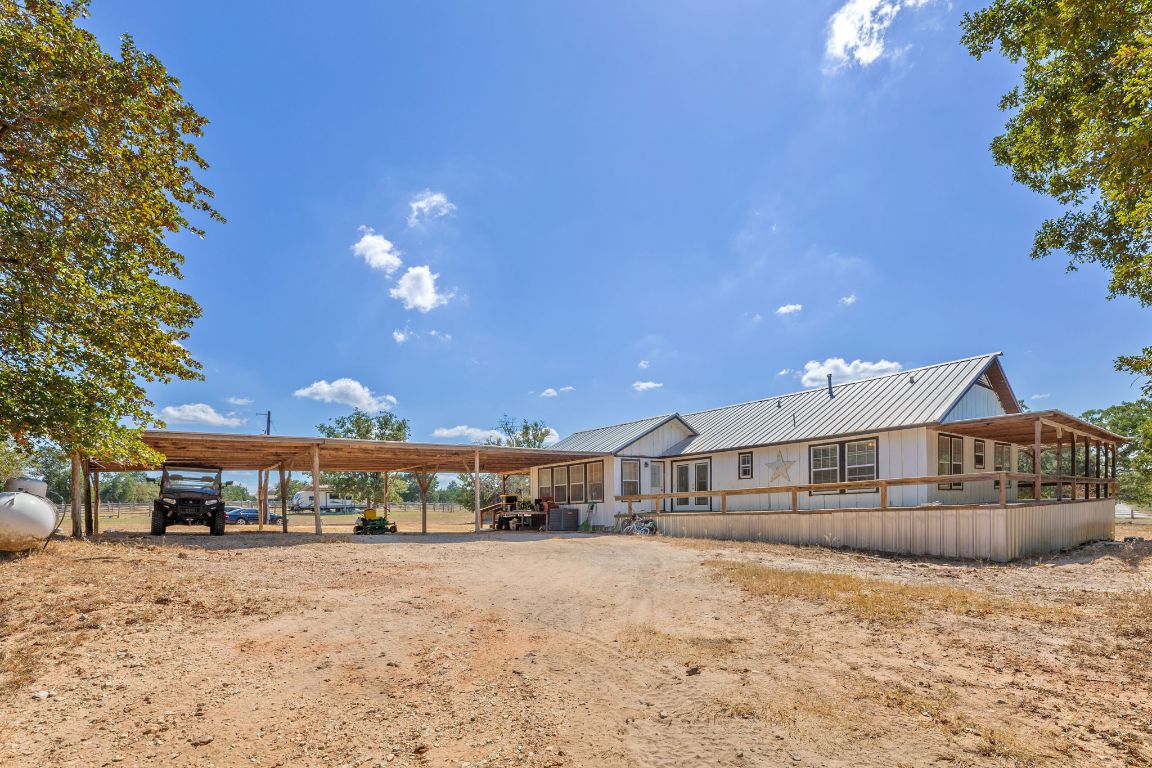 274 Old Potato Road Paige, TX 78659 - Photo 7 of 40 a front view of a house with a yard and tree s