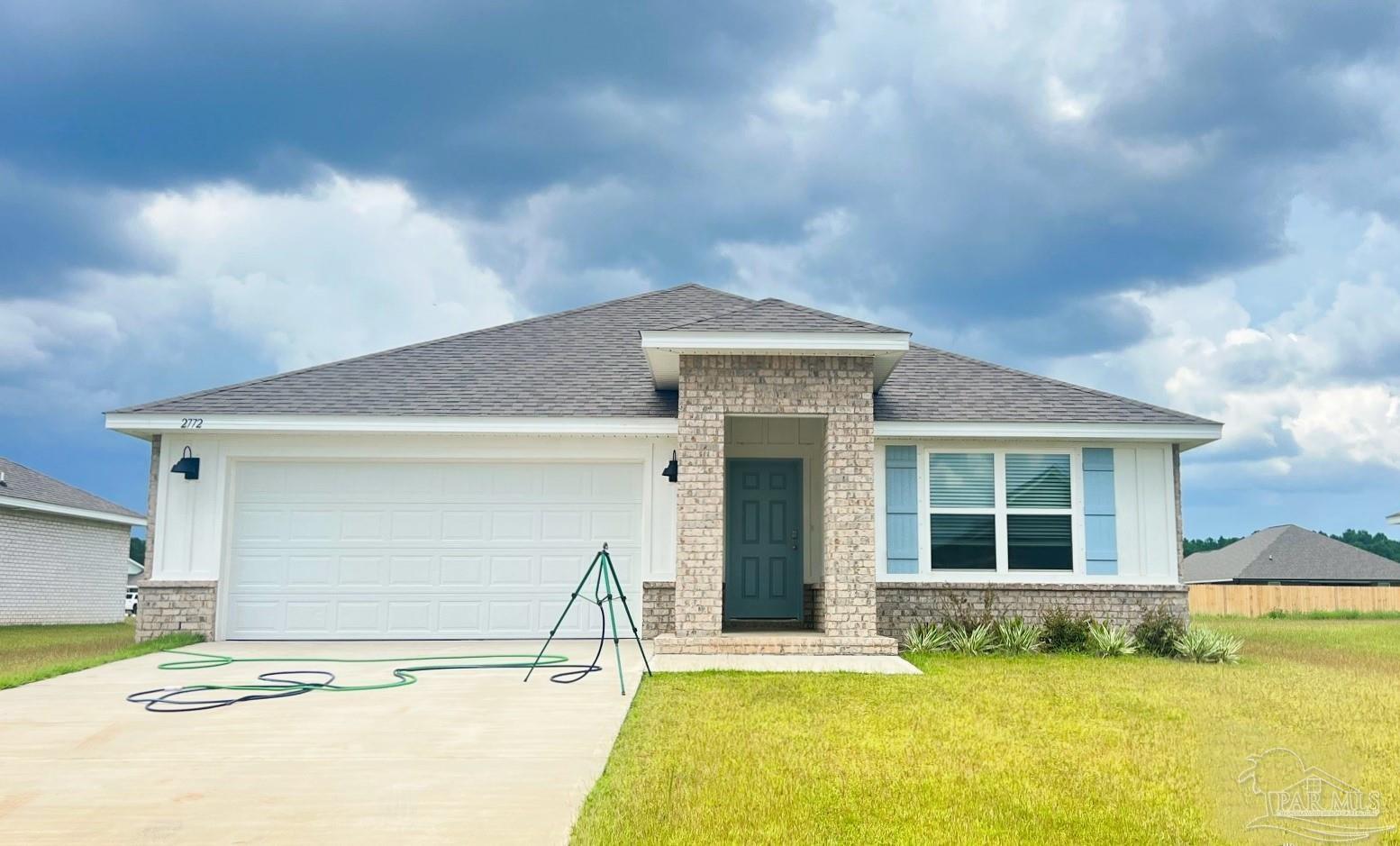 a front view of a house with a yard