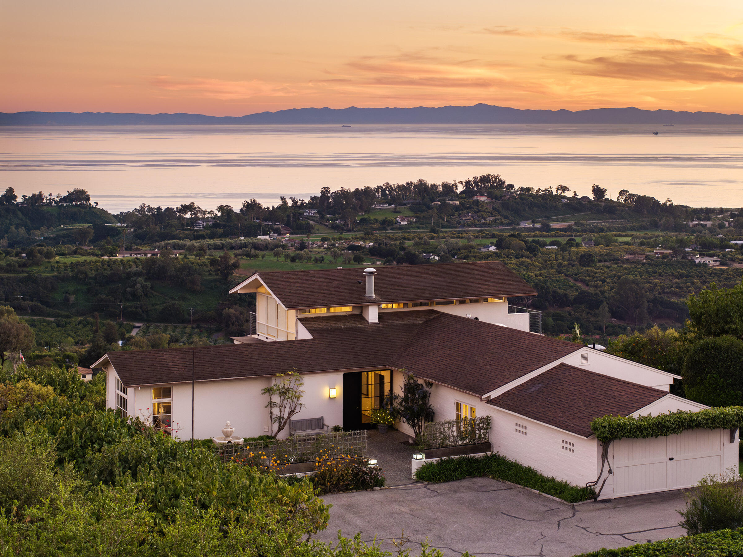 an aerial view of house with ocean view