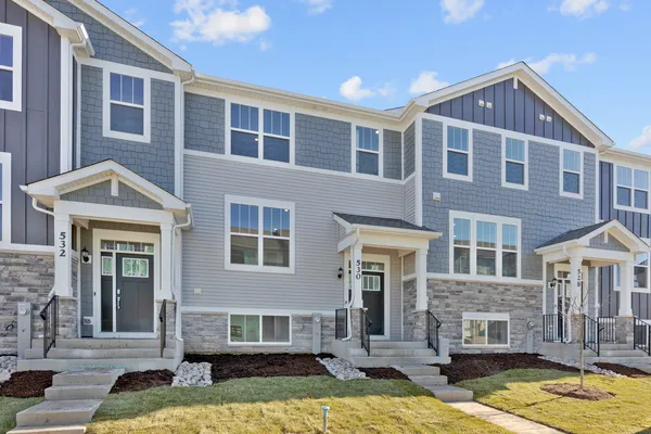 a front view of a residential apartment building with a yard