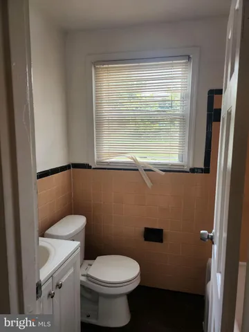 a bathroom with a toilet a sink and a window