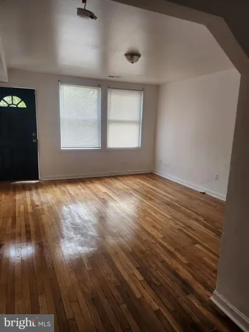 an empty room with wooden floor