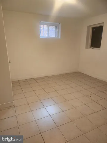 a white toilet sitting next to a white cabinet