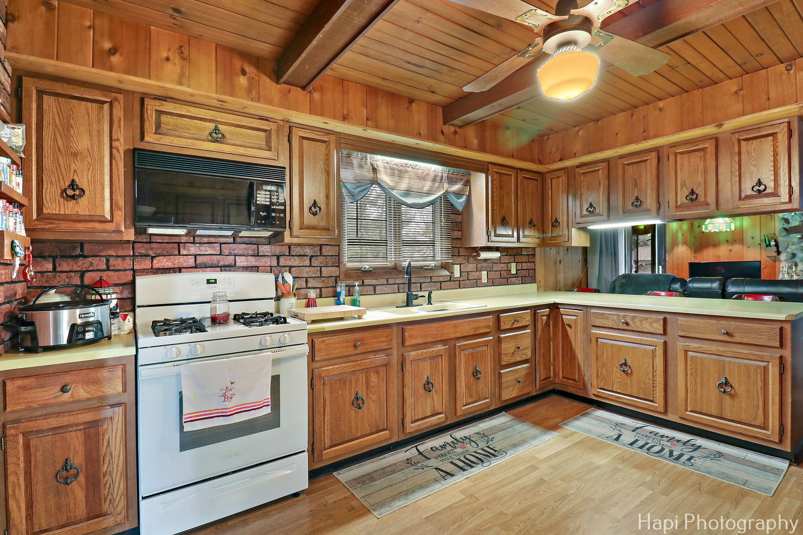 6217 Johnsburg Road Spring Grove, IL 60081 - Photo 8 of 28 a kitchen with a stove a sink and a microwave