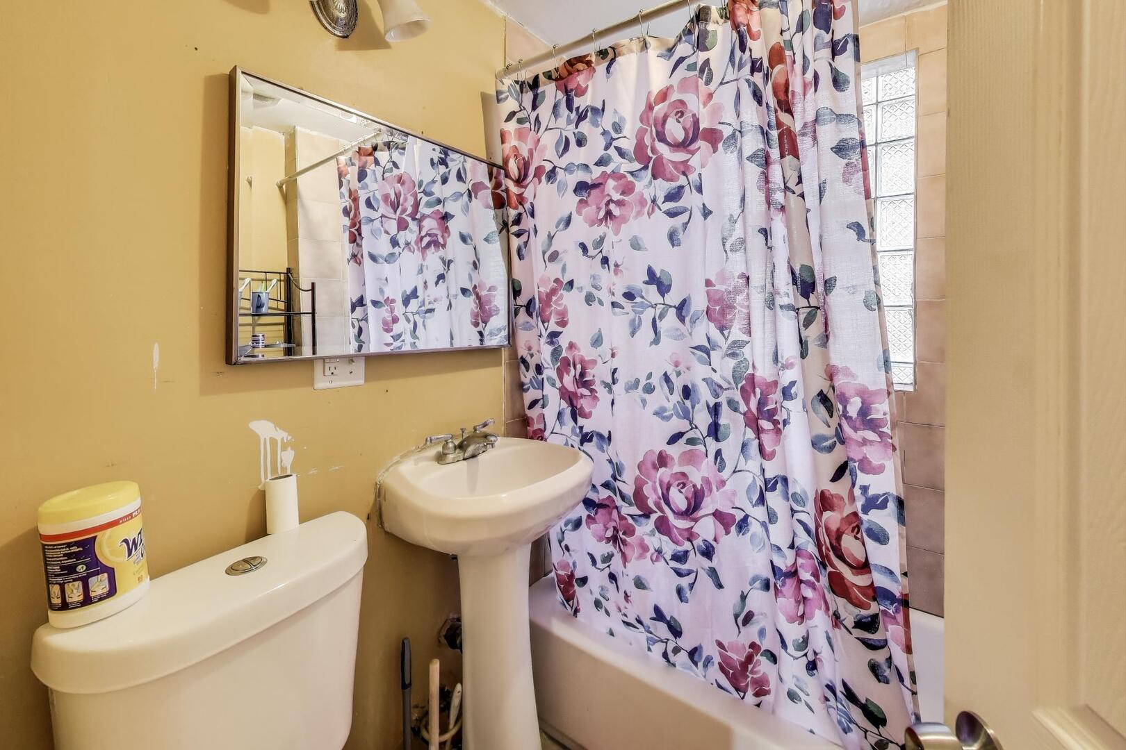 8822 South Ada Street Chicago, IL 60620 - Photo 11 of 25 a bathroom with a sink and mirror with toilet