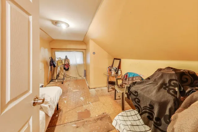 a view of a living room with furniture and a floor to ceiling window