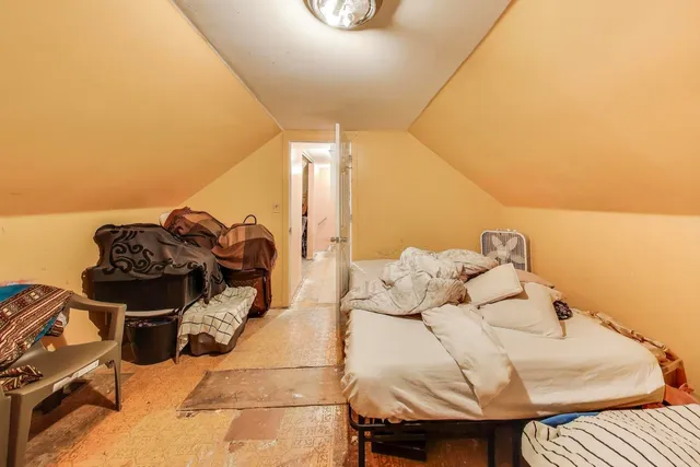 a bedroom with a bed and a night stand