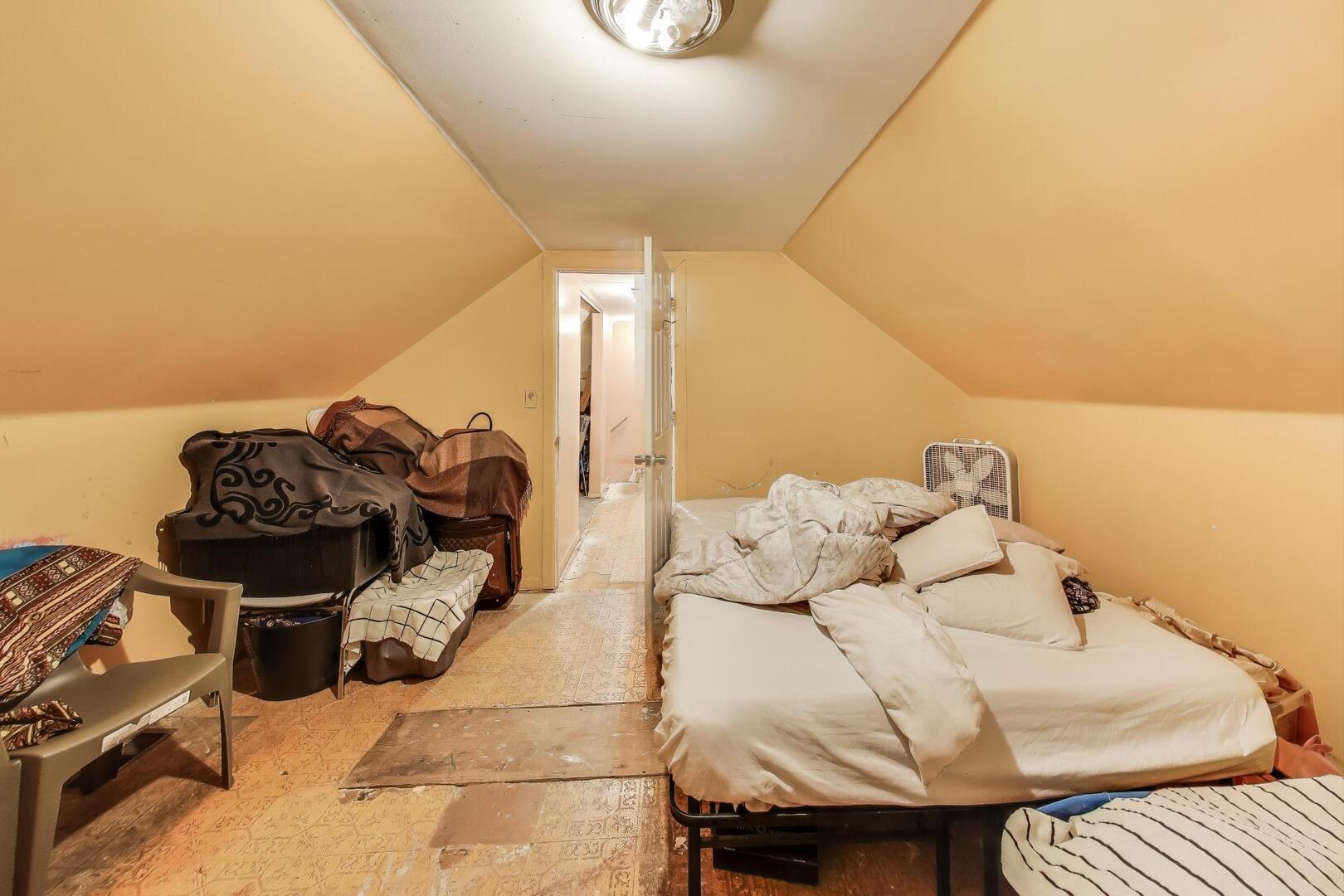 8822 South Ada Street Chicago, IL 60620 - Photo 16 of 25 a bedroom with a bed and a night stand